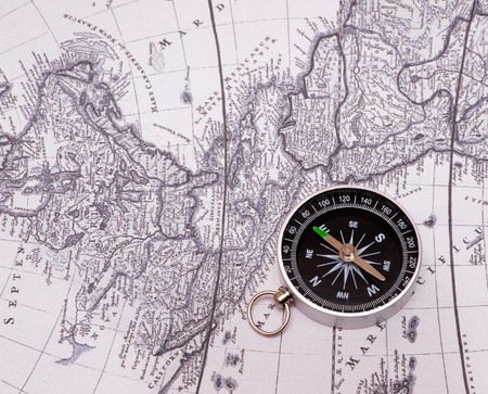 The compass lies on an old cardの写真素材