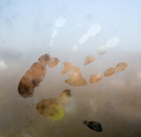 imprint of a person's palm to sweaty glassの写真素材