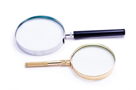 two magnifying glasses in black and gold colorの写真素材