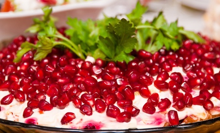 Salad with mayonnaise and garnet grains on a plateの写真素材