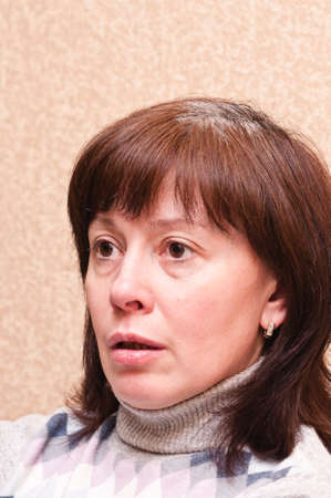 middle-aged woman looks thoughtfullyの写真素材