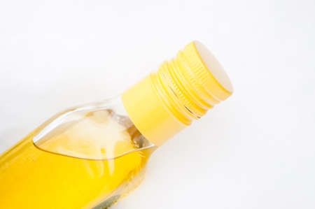 bottle with yellow liquid in the snowの写真素材