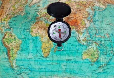 The compass lies on the modern world mapの写真素材