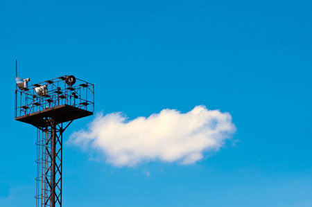 tower with a spotlight on the background of sky with cloudsの写真素材