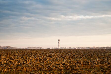 tractor plowed field in the spring morningの写真素材