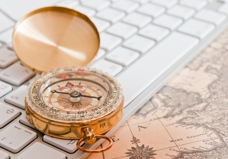 The compass lies on an old cardの写真素材