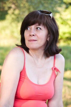 middle-aged woman looks thoughtfullyの写真素材