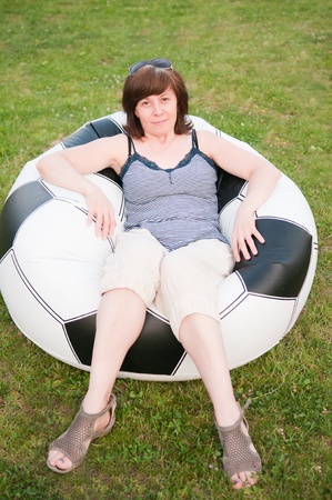 middle-aged woman looks thoughtfullyの写真素材