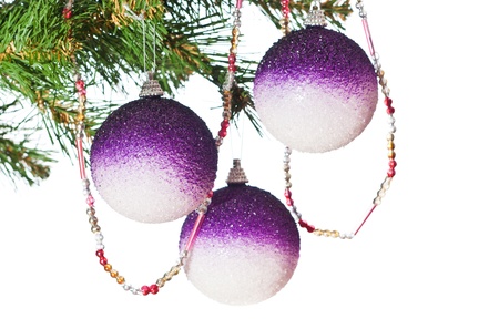 Three gold balls on a Christmas fur-treeの写真素材