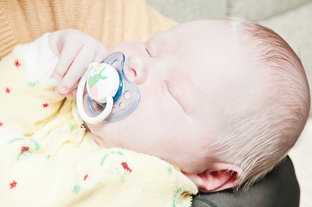 little newborn baby sleeps with his mouth openの写真素材