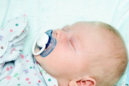 Newborn baby lying in a blanketの写真素材