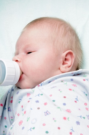 Newborn baby lying in a blanketの写真素材