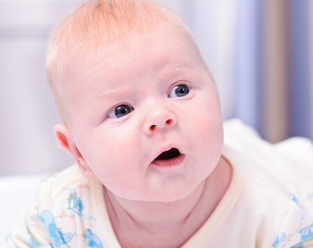 little newborn baby looks thoughtfullyの写真素材