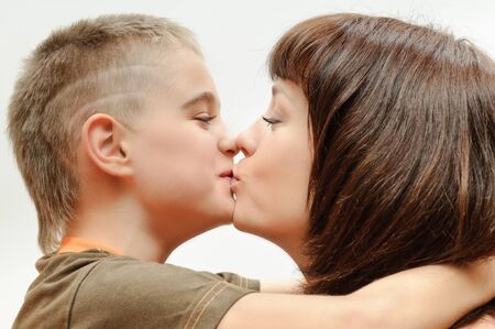woman hugging her son with loveの写真素材