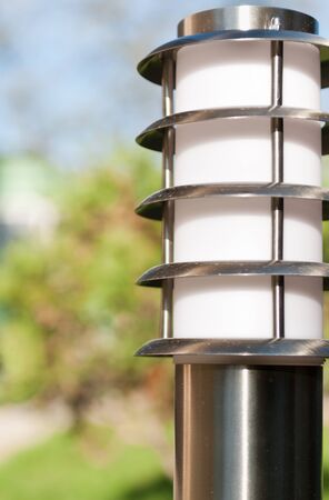 small lantern in a garden on the groundの写真素材
