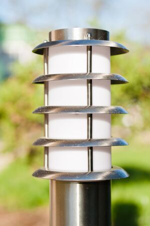 small lantern in a garden on the groundの写真素材