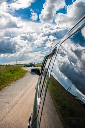 part of the car against the sky with a cloudの写真素材