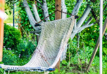 old hammock hanging in the gardenの写真素材