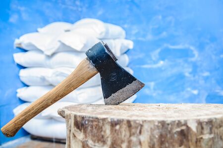 an old ax stuck in a wooden deckの写真素材