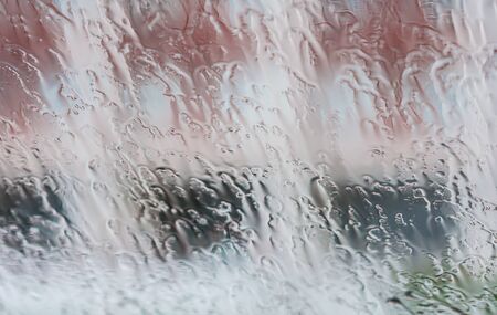 rain drops on glass with a backgroundの写真素材