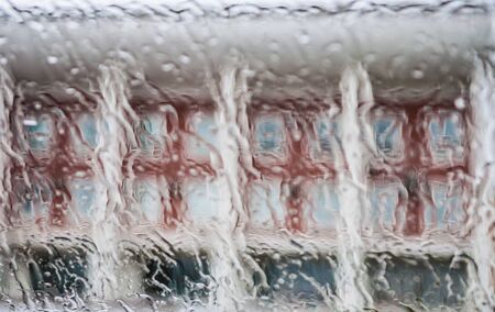 rain drops on glass with a backgroundの写真素材