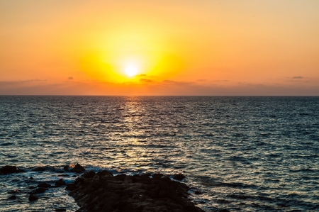 colorful and orange sunset over the seaの写真素材