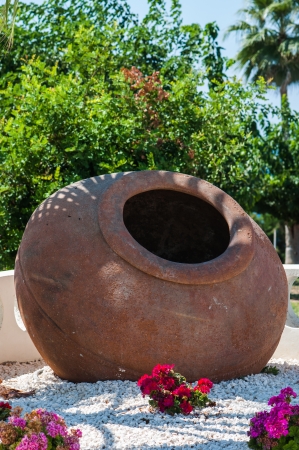 old pottery crock as decoration is on the groundの写真素材
