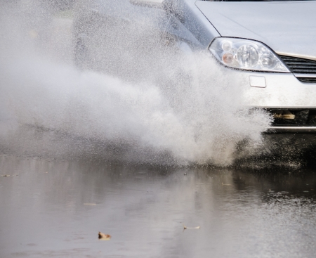 Car rides on big water in the rainの写真素材