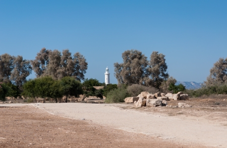 Coast white lighthouse against a blue sky on the island of Cyprusの写真素材