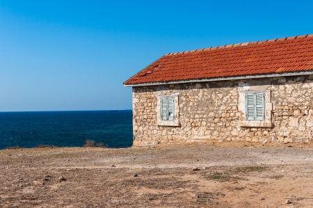 old house with red roof on the beachのeditorial素材
