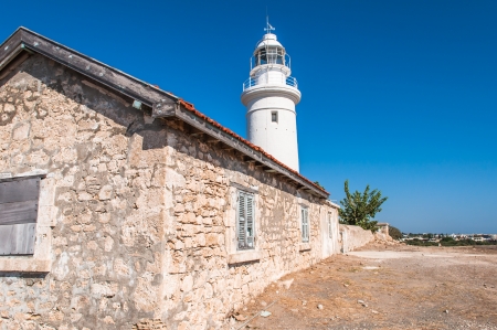 white lighthouse and the old house on the island of Cyprusのeditorial素材