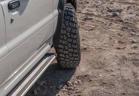 turn the wheel of an SUV with great treadの写真素材