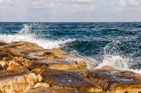 waves on the sea landscape on a background of blue sky with cloudsの写真素材