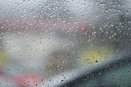 rain drops on glass with a backgroundの写真素材