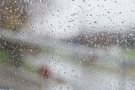 rain drops on glass with a backgroundの写真素材