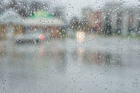 rain drops on glass with a backgroundの写真素材