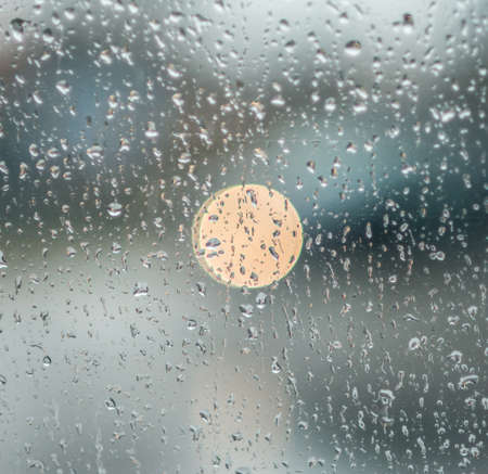 rain drops on glass with a backgroundの写真素材