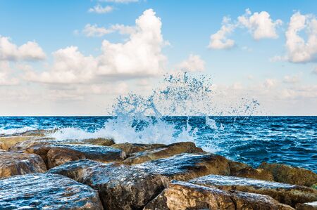 waves on the sea landscape on a background of blue sky with cloudsの写真素材