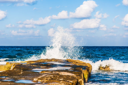 waves on the sea landscape on a background of blue sky with clouds