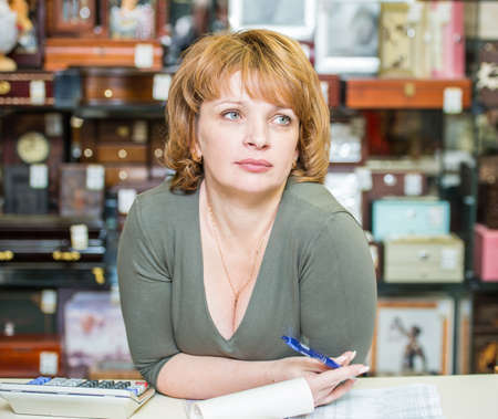 middle-aged woman checks the documents of your businessの写真素材
