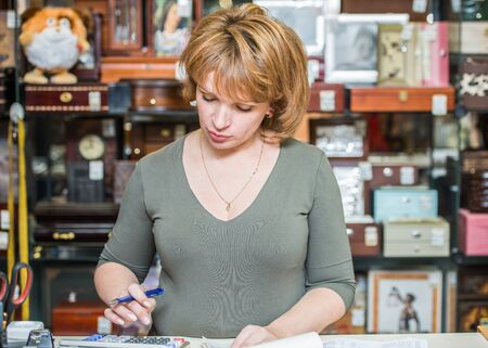 middle-aged woman checks the documents of your businessの写真素材