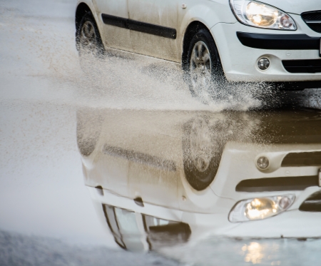 Car rides on big water in the rainの写真素材