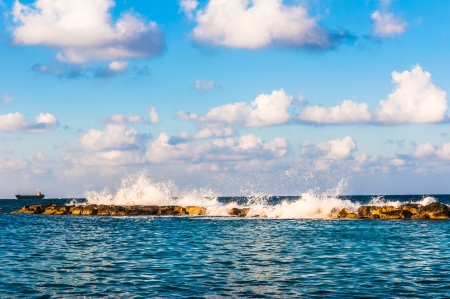 waves on the sea landscape on a background of blue sky with cloudsの写真素材