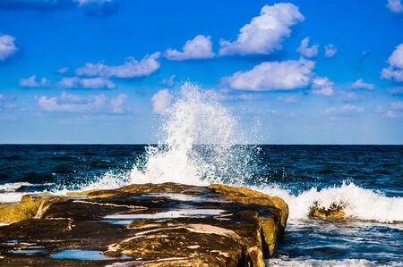 waves on the sea landscape on a background of blue sky with cloudsの写真素材