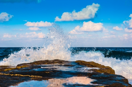 waves on the sea landscape on a background of blue sky with cloudsの写真素材