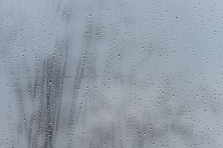 rain drops on glass with a backgroundの写真素材