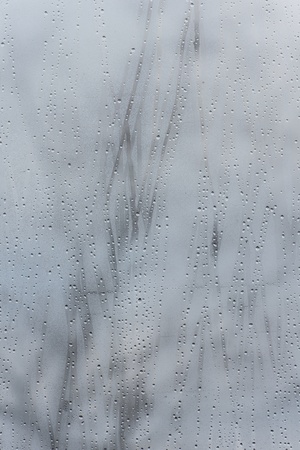 rain drops on glass with a backgroundの写真素材