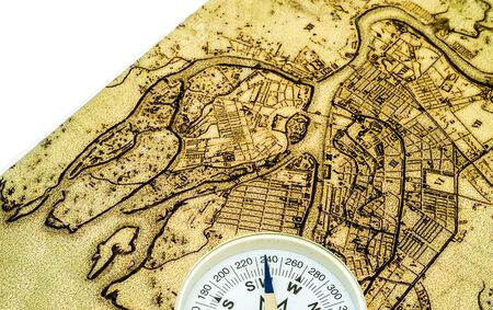 old burnt World Map with compass on a white backgroundのeditorial素材