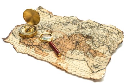 old burnt World Map with compass on a white backgroundの写真素材