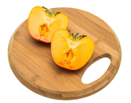 juicy persimmon cut in half is on the boardの写真素材